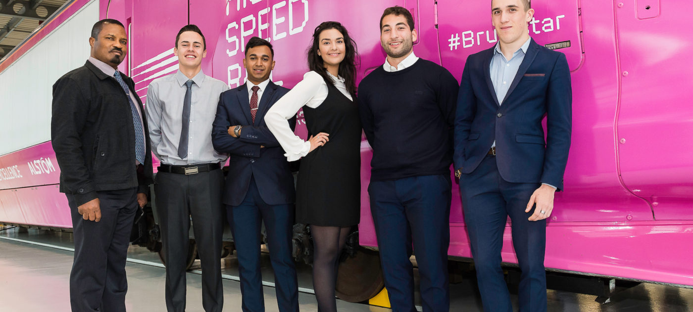 HS2 apprentices posing in front of a mock high speed train