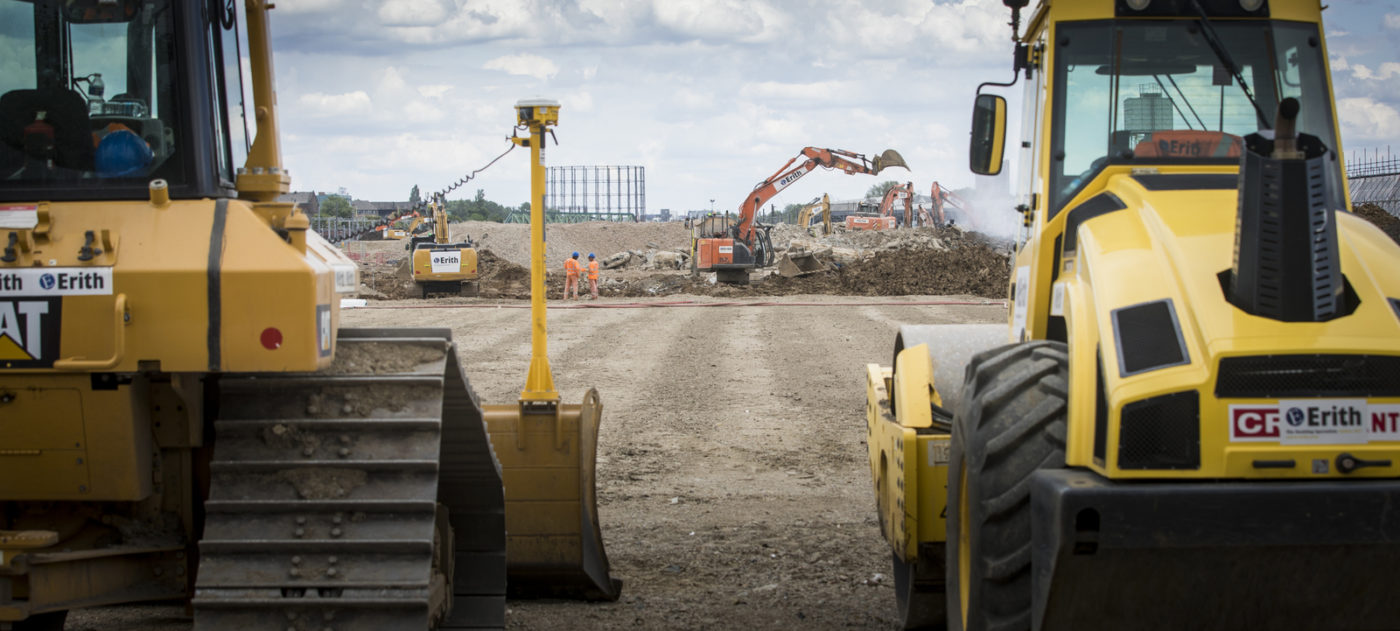 Constrution vehicles parked in front of leveled land
